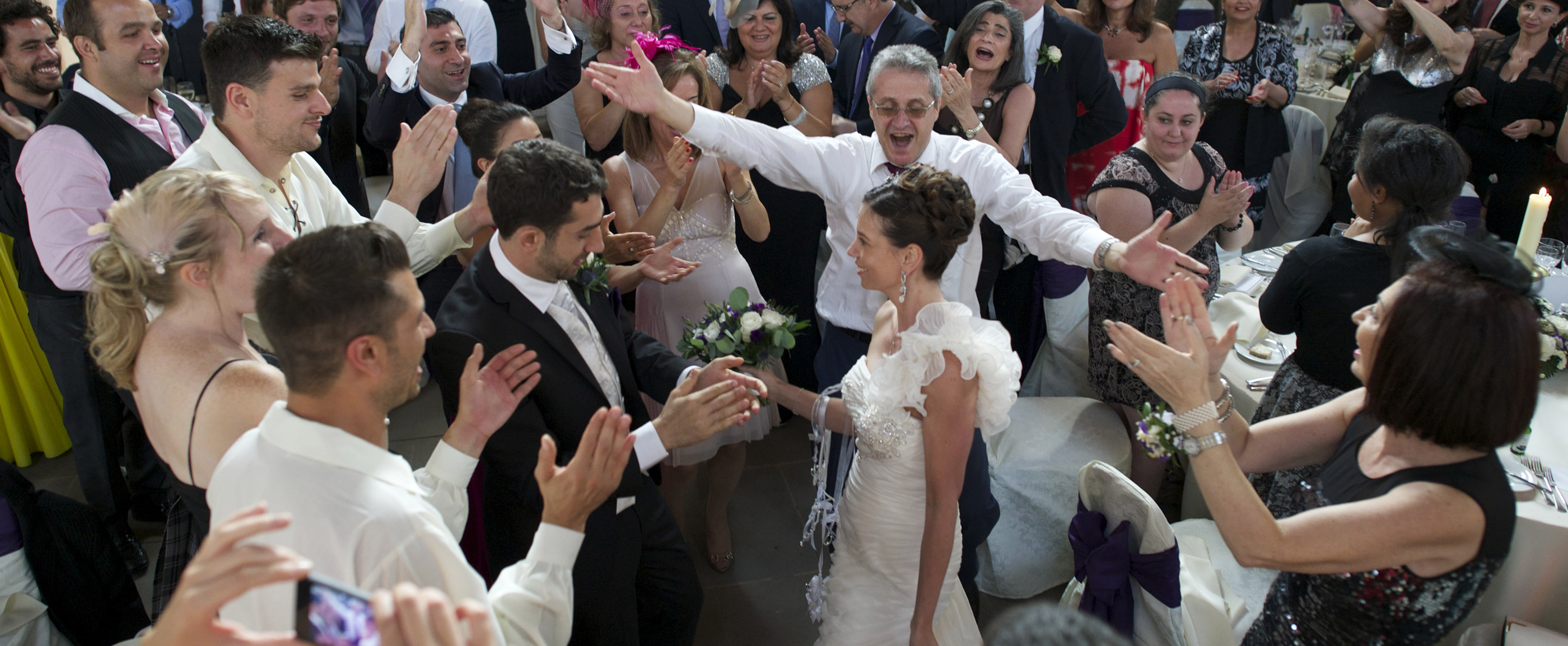 Bride and groom being welcomed to their wedding reception by their guests