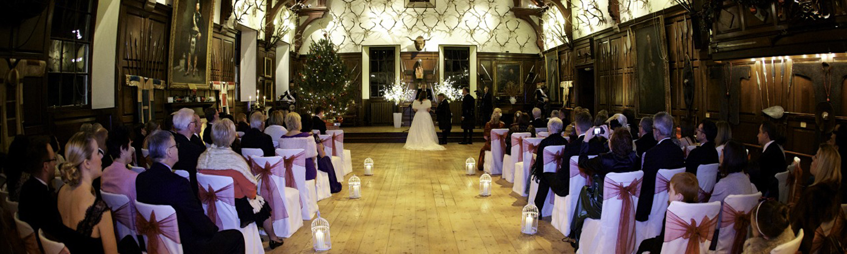 Blair Castle wedding ceremony Photo of a wedding ceremony taking place in one of the grand wood paneled halls in Blair Castle
